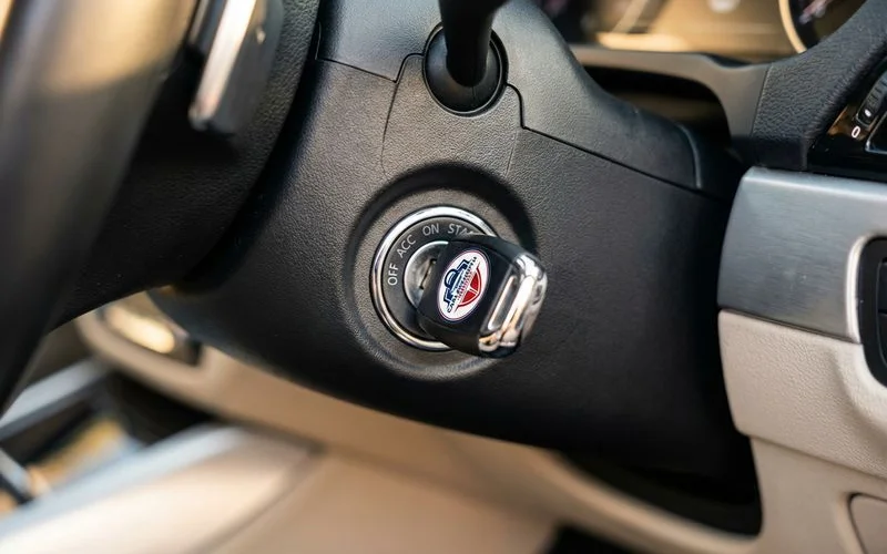 Close-up of car ignition barrel showing key insertion point and steering column